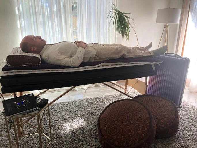 man laying on infrared mat